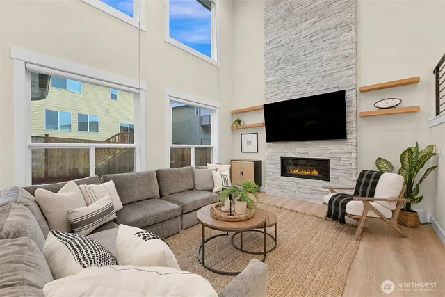 a living room with furniture a flat screen tv and a fireplace
