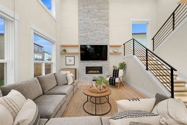 a living room with furniture and a view of kitchen