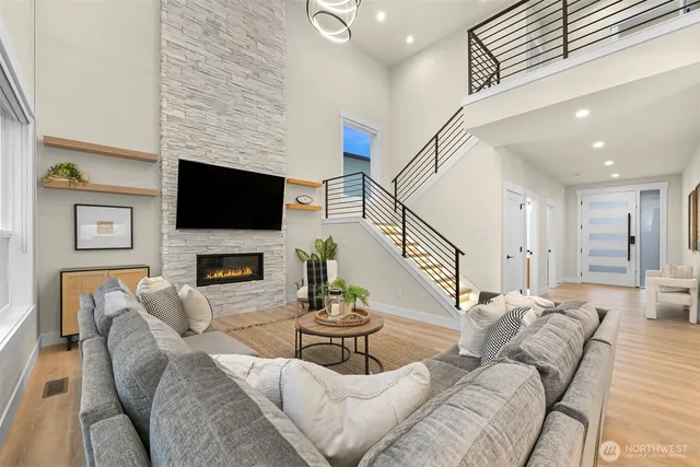 a living room with furniture kitchen view and a chandelier