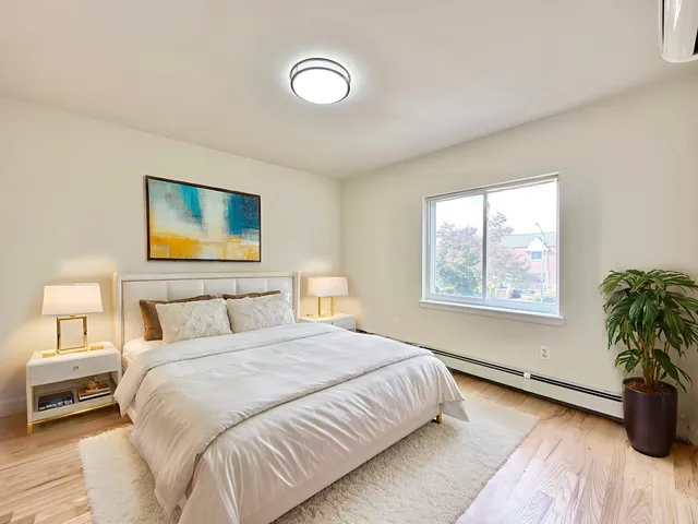 a bedroom with a bed and a potted plant