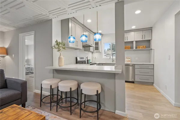 a kitchen with cabinets and chairs