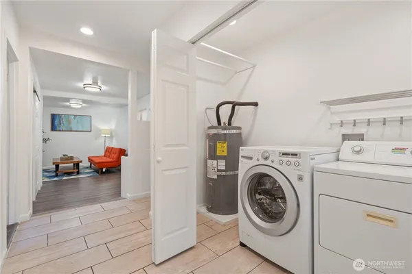 a view of a hallway with wooden floor and cabinet