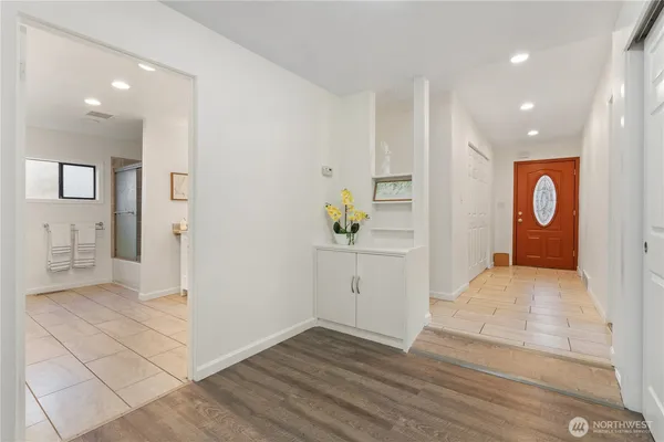 a room with white cabinets and window