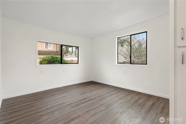 a bedroom with a bed and a potted plant