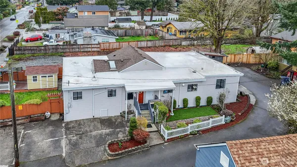 an aerial view of a house with a garden and street view