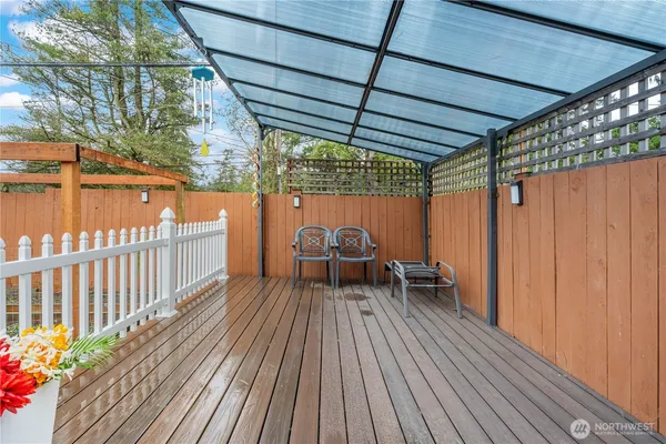 a view of a porch with wooden floor and fence
