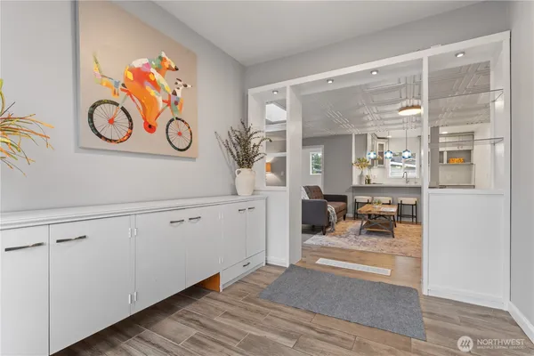 a view of a closet area with furniture and wooden floor