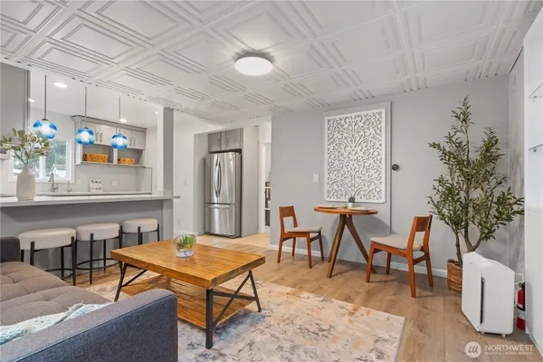 a living room with patio furniture and a potted plant