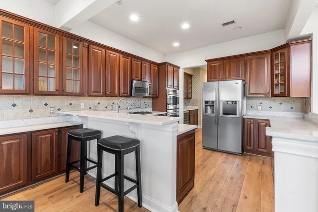 a kitchen with stainless steel appliances granite countertop a refrigerator sink and cabinets