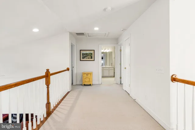 a view of a hallway with paintings on the wall