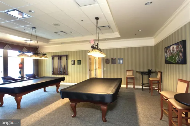 a living room with furniture a chandelier and a flat screen tv