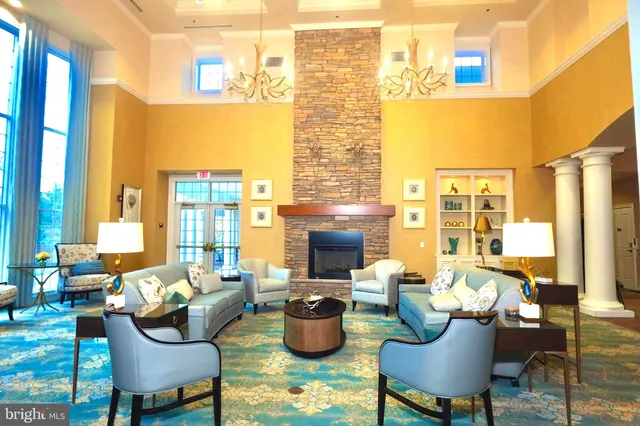 a living room with furniture and floor to ceiling windows