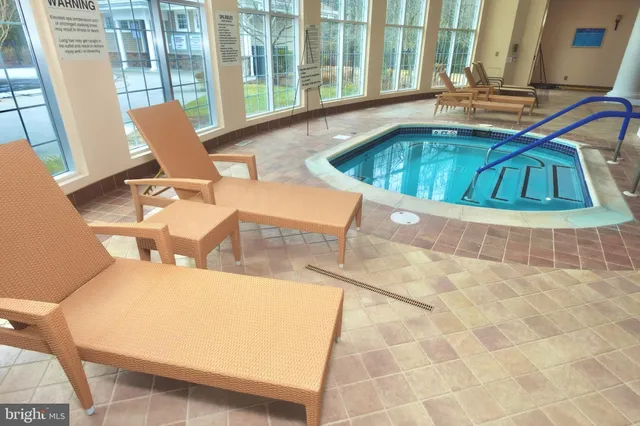 a view of a kitchen with furniture and large windows