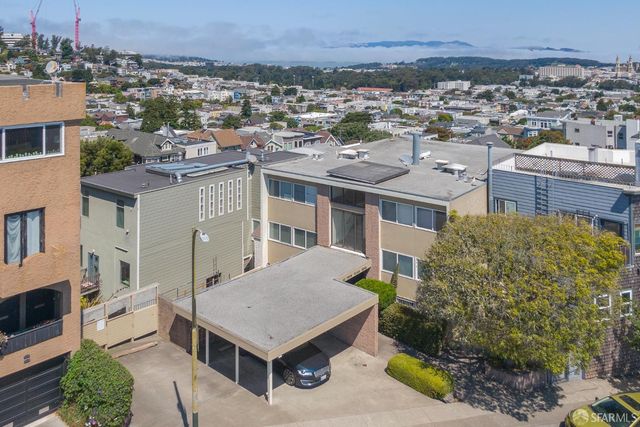 a view of a city that has tall buildings and a big yard