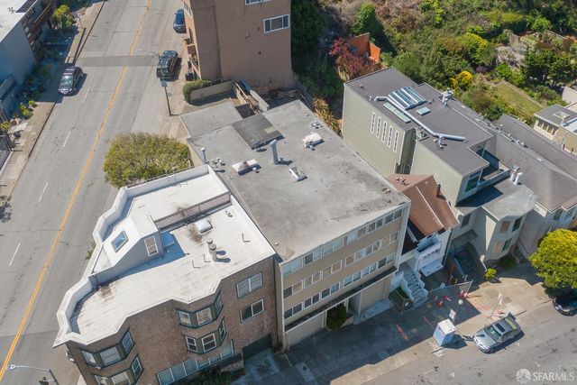 an aerial view of a house with outdoor space and parking