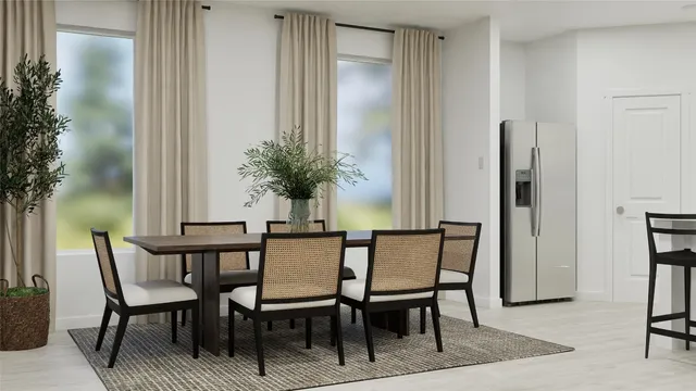 a view of a dining room with furniture and window