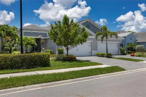 a front view of a house with a yard and a garage