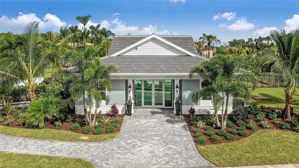 2401 Ariane Drive Naples, FL 34112 - Photo 14 of 17 a view of a house with sitting area and garden