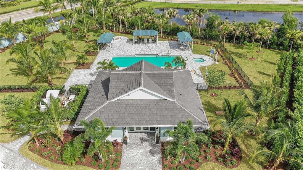 2401 Ariane Drive Naples, FL 34112 - Photo 15 of 17 a view of outdoor space swimming pool and lake view