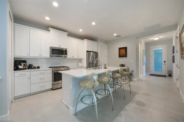 a view of a hallway with wooden floor and livingroom