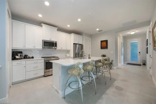 a view of a hallway with wooden floor and livingroom