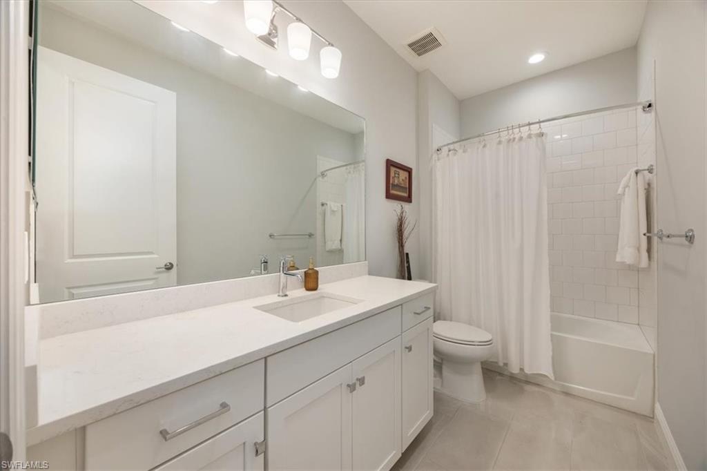 2401 Ariane Drive Naples, FL 34112 - Photo 10 of 17 a bathroom with a sink a toilet and shower
