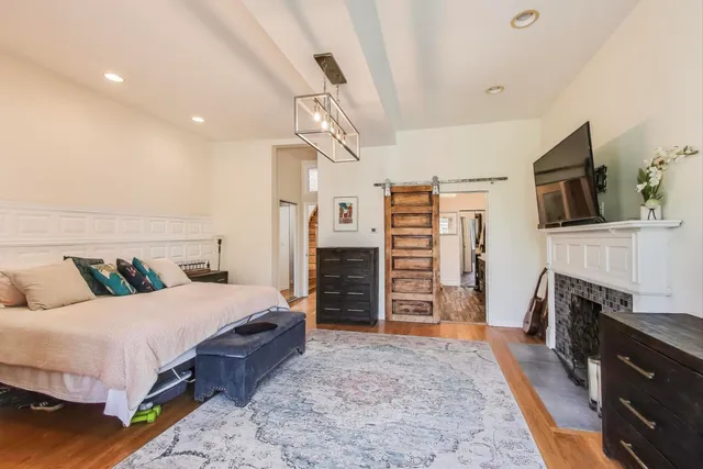 a bedroom with a bed and a chandelier