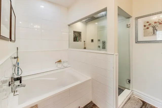 a bed room with a bed mirror and a window