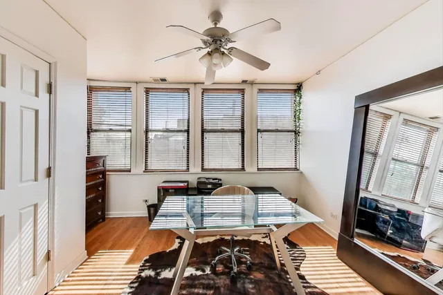 a view of hallway with wooden floor and a window