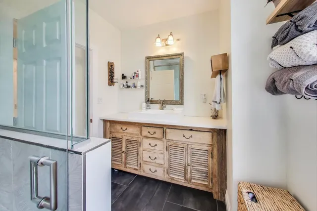 a bathroom with a sink a toilet and shower curtain