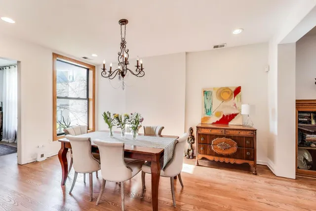 a kitchen with stainless steel appliances a sink stove and wooden floor