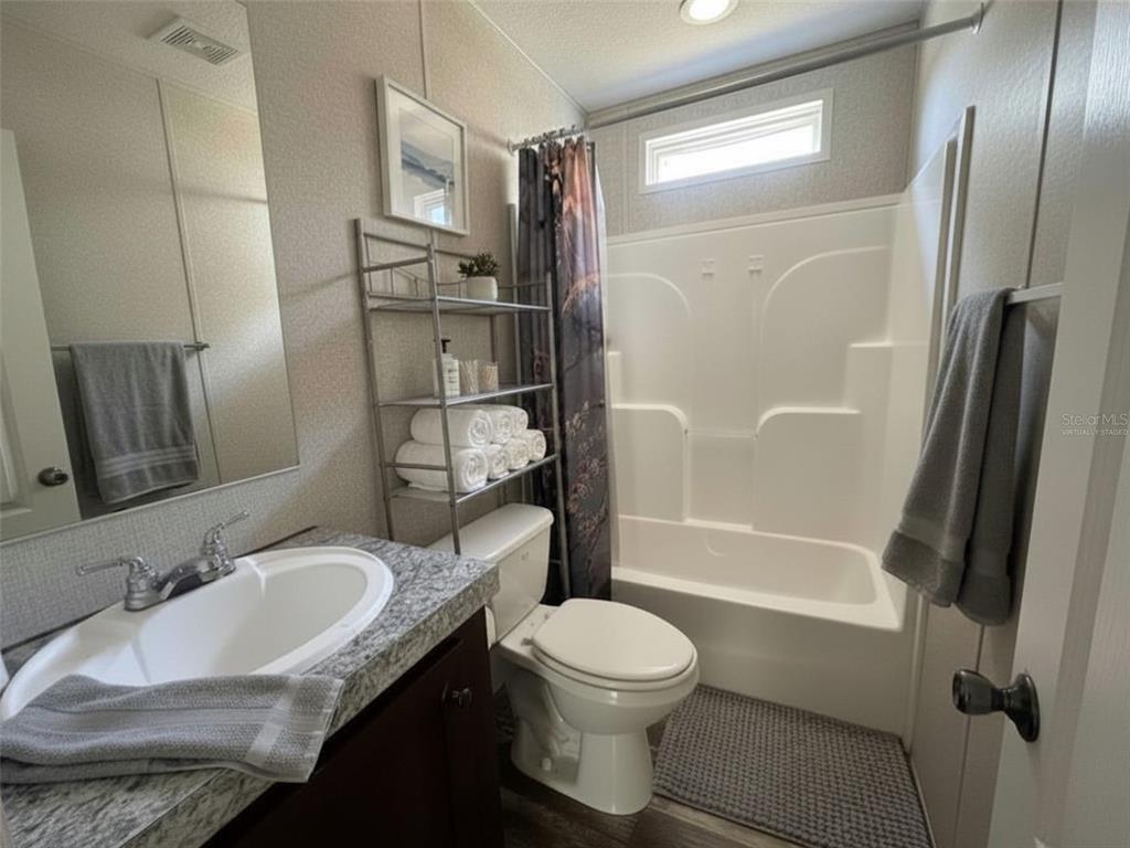 9827 Southeast Hoth Road Arcadia, FL 34266 - Photo 24 of 28 a bathroom with a granite countertop sink toilet and shower