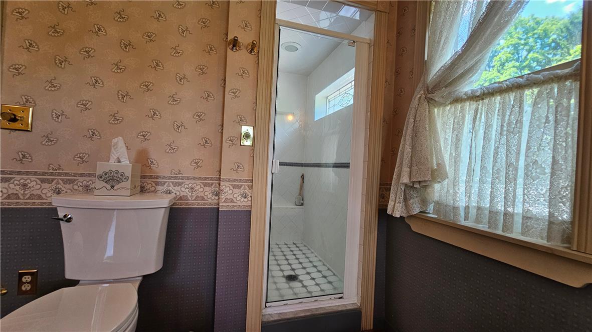 585 Buttermilk Road Hellertown, PA 18055 - Photo 37 of 82 A quaint bathroom with a shower and a window offering natural light.