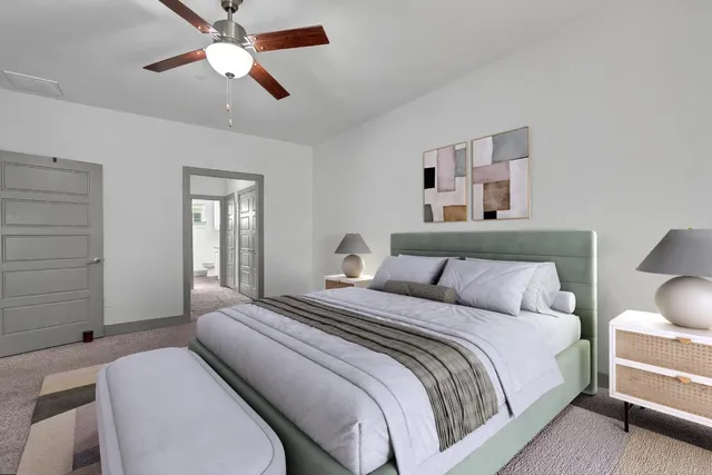 a bedroom with a bed and a chandelier