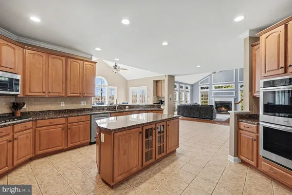 a kitchen with stainless steel appliances granite countertop a refrigerator and a sink