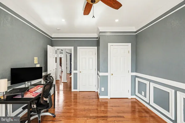 a view of a bedroom with furniture wooden floor and window