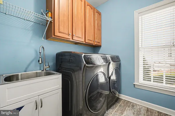a bathroom with a granite countertop sink mirror bathtub and toilet