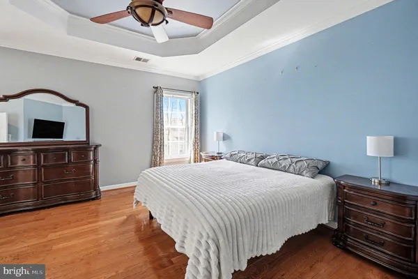 a bedroom with a bed and flat screen tv