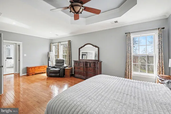 a bedroom with a bed and a table chair