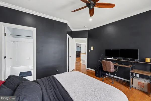 a living room with furniture and a flat screen tv with bookshelf