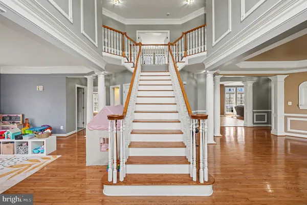 a view of entryway and hall with wooden floor