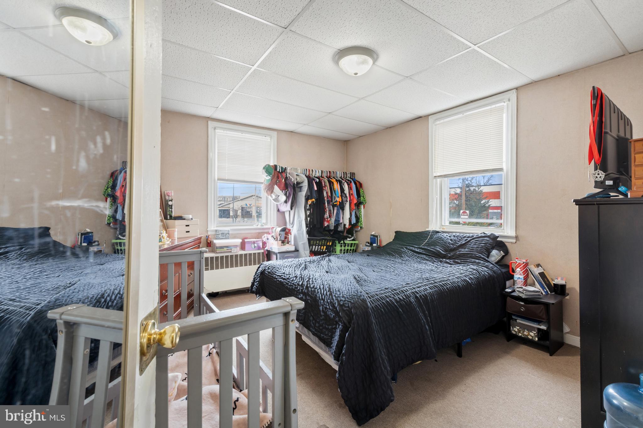 6136 Hawthorne Street Philadelphia, PA 19135 - Photo 12 of 38 a bedroom with a bed and a flat tv screen