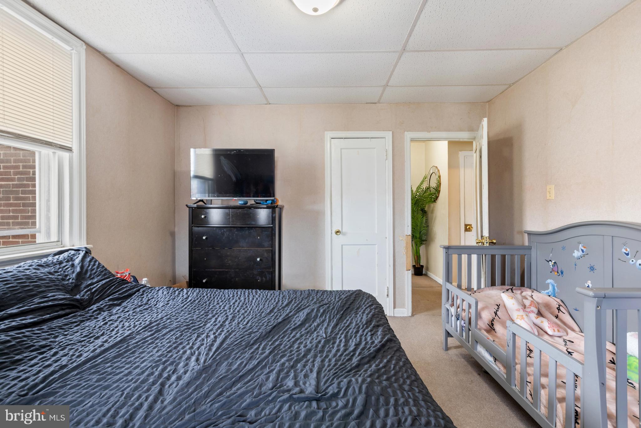 6136 Hawthorne Street Philadelphia, PA 19135 - Photo 13 of 38 a bedroom with a bed and a flat tv screen