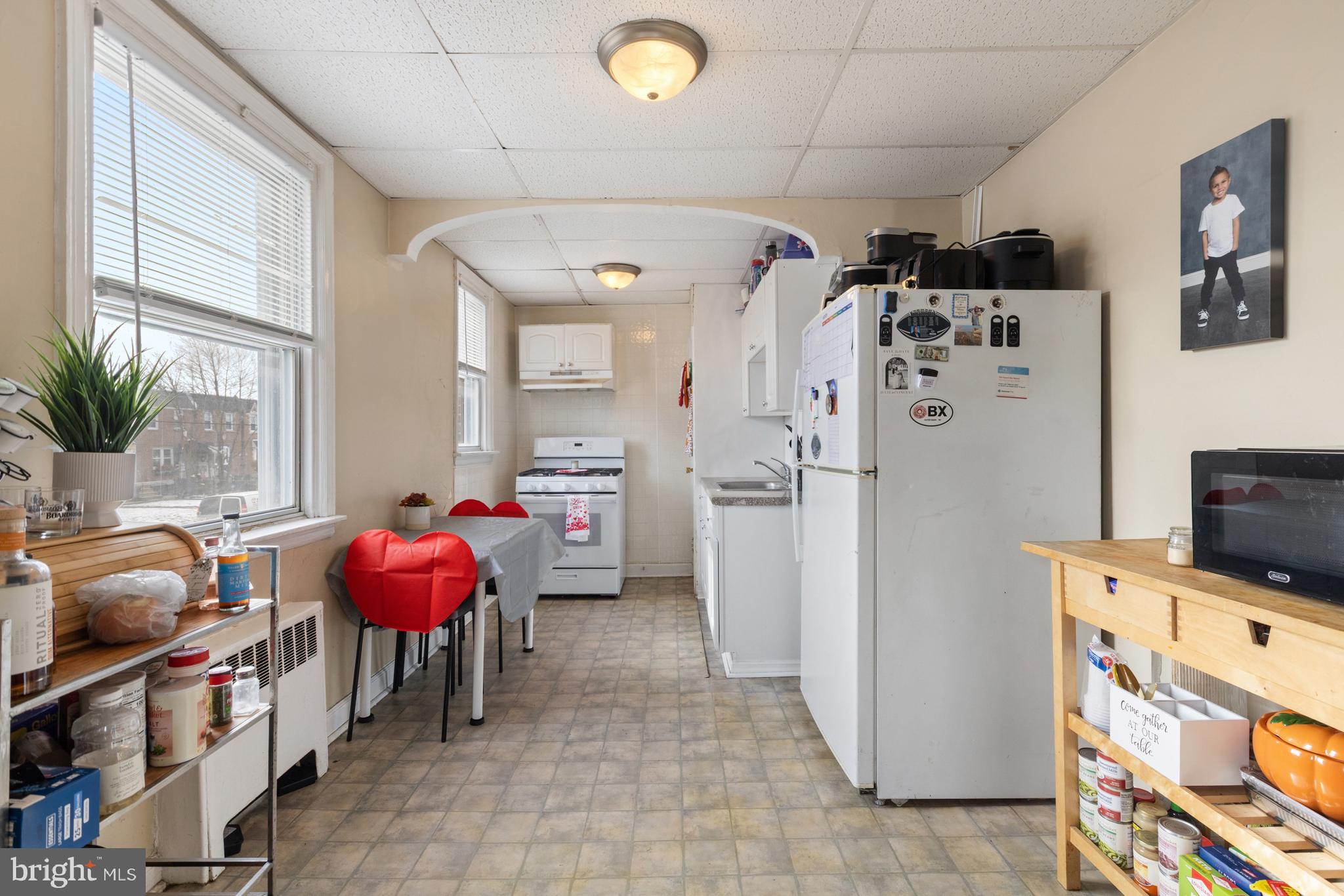 6136 Hawthorne Street Philadelphia, PA 19135 - Photo 8 of 38 a kitchen with granite countertop a refrigerator and a stove