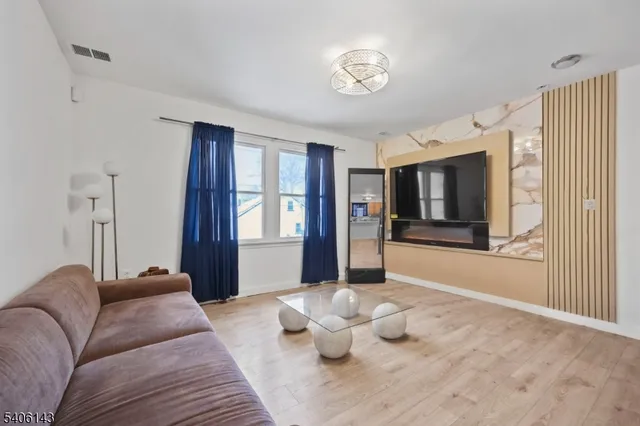 a bedroom with furniture and large windows