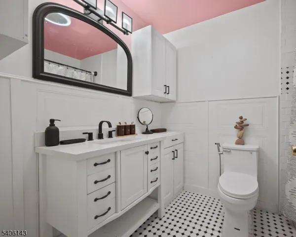 a bathroom with a toilet a sink and mirror