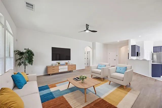 a living room with furniture and a flat screen tv