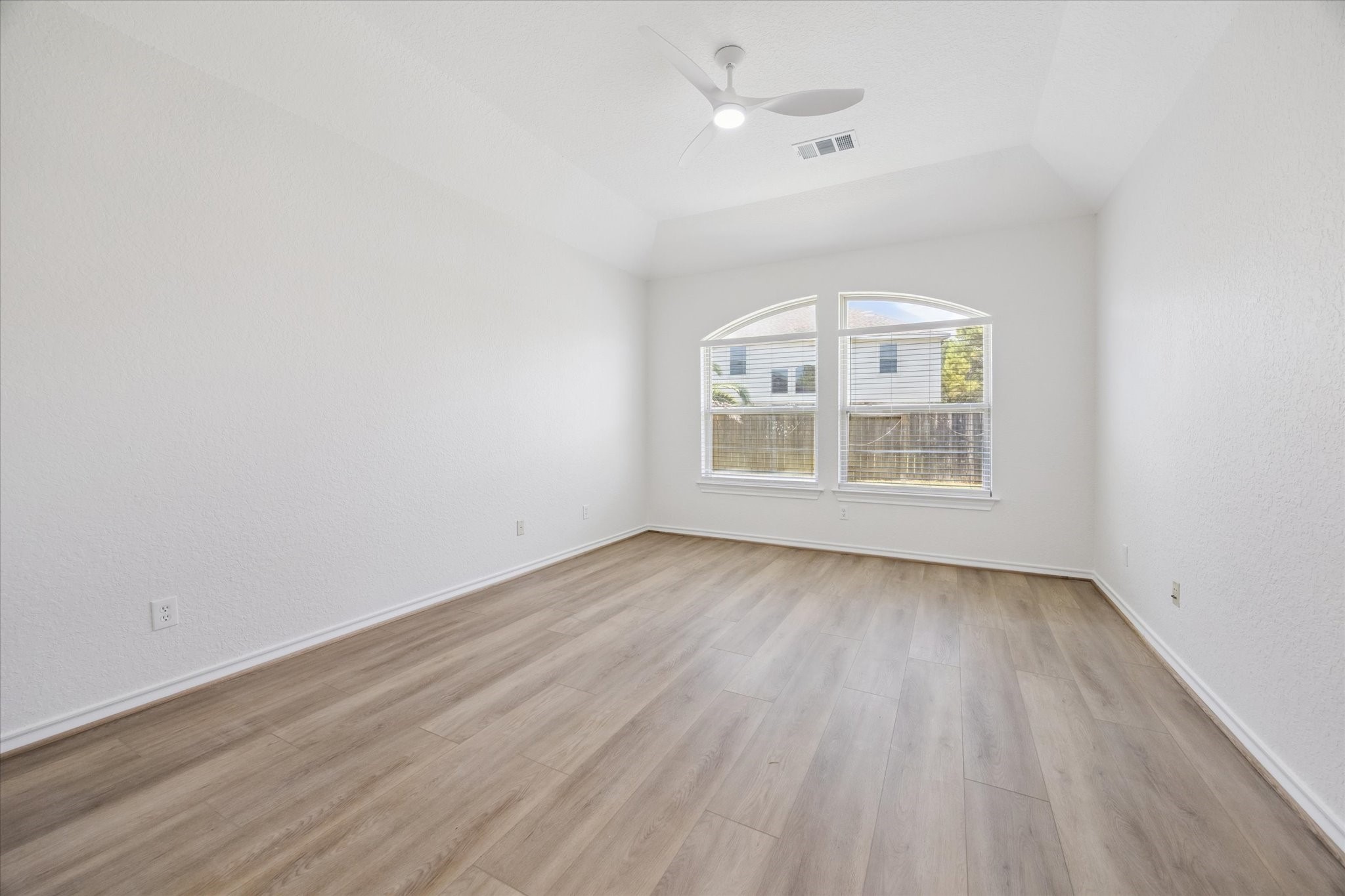 26110 Pointer Ridge Lane Katy, TX 77494 - Photo 16 of 25 an empty room with wooden floor chandelier fan and windows