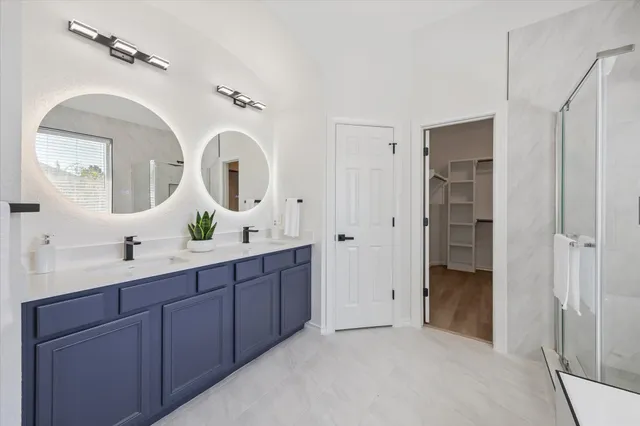a spacious bathroom with a double vanity sink and a mirror