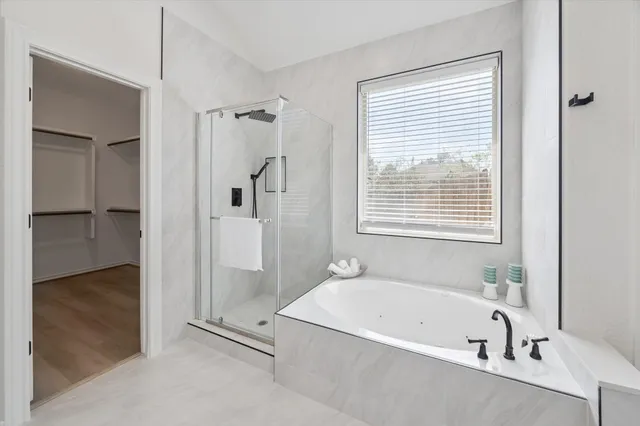 a bathroom with a bathtub and a shower